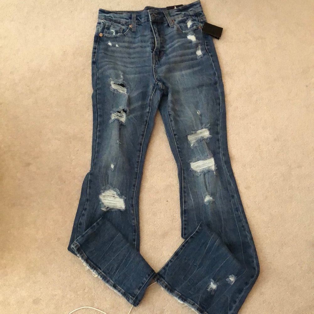Distressed medium blue flare denim